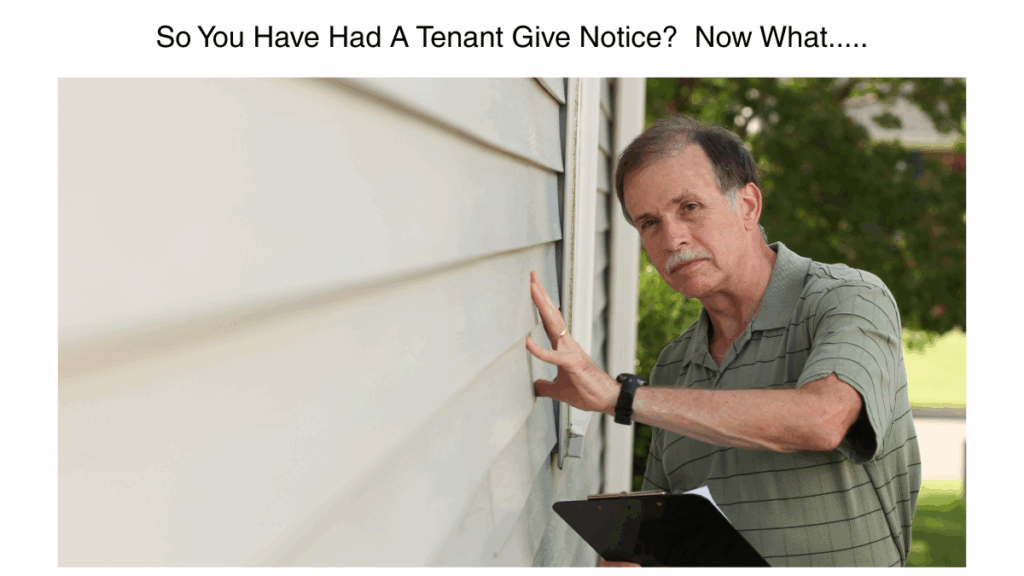 Landlord inspecting rental property with clipboard after receiving tenant move-out notice in Washington